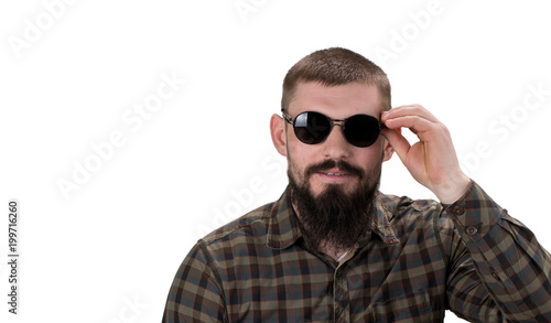 closeup portrait of a young casual man  in sunglasses looking  into the camera on white background