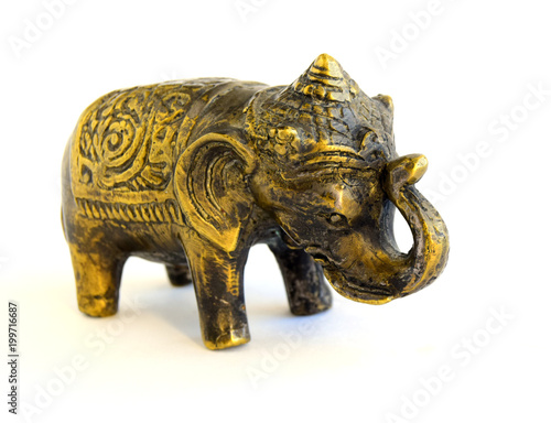 The sculpture of an elephant is made of old bronze. The sculpture is located on a white background