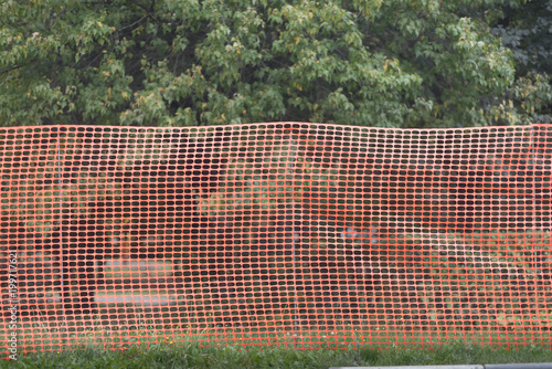 Red plastic industry protection fence on road side photo