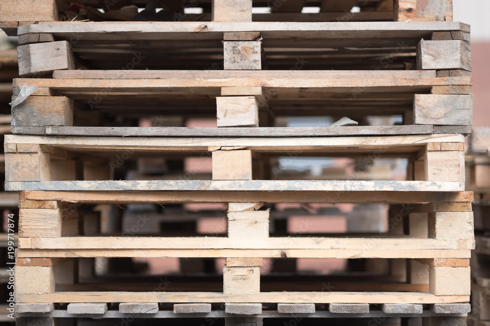 Stacks of old wooden pallets in an industrial yard. Stacks of old wooden pallets in an industrial yard.