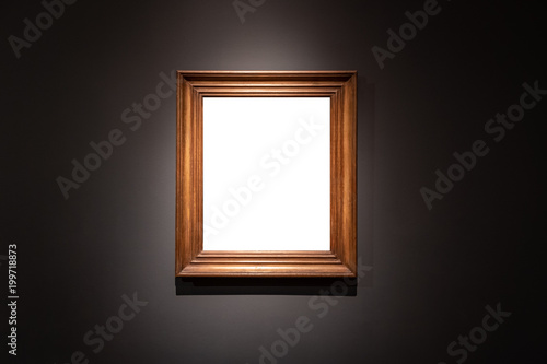 Konstfotografi Blank hanging individual frame in an art gallery black background