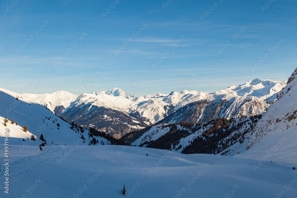 Alps winter landscape of slopes, off piste skiing, snowboarding in French resort of Courchevel, Les Trois Vallees , on a sunny day. France 2018. Alps winter landscape of slopes, off piste skiing, snowboarding in French resort of Courchevel, Les Trois Vallees , on a sunny day. France 2018.