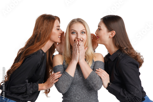 Three girlfriends sharing gossip