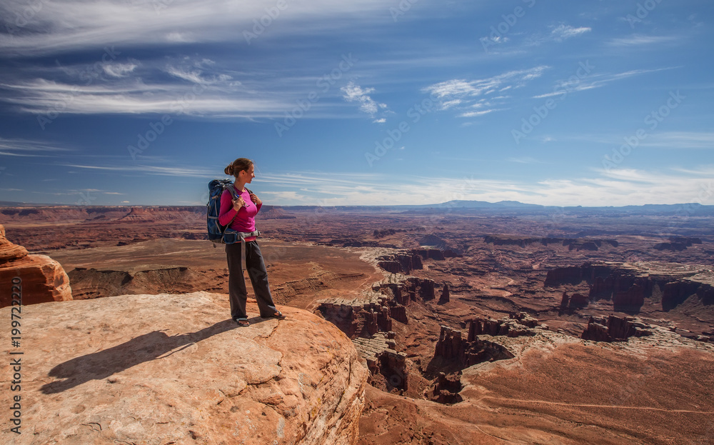 Hiker rests in Canyonlands National park in Utah, USA