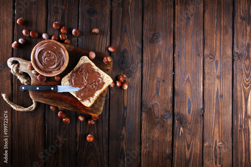 Homemade hazelnut spread with toast and in wooden bowl for breakfast. Hazelnut Nougat cream