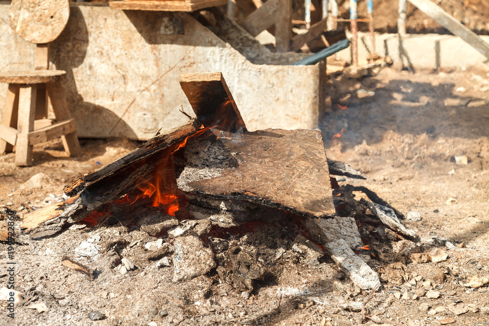 Flame of fire from firewood and building wooden boards Flame of fire from firewood and building wooden boards