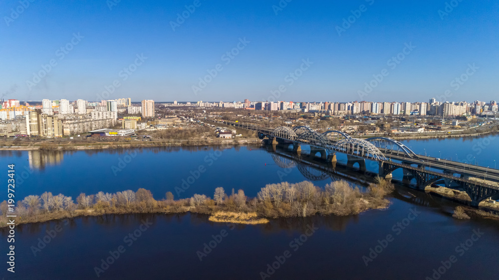 Aerial view of the Kiev city, Ukraine. Dnieper river with bridges. Darnitskiy bridge