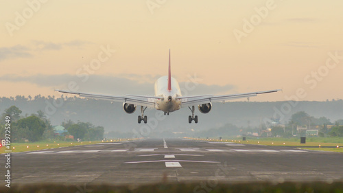 Landing aircraft at the airport of the city of Legazpi early in the morning. Philippines.
