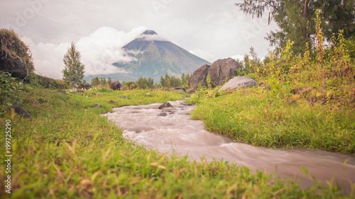 Foothills of the Mayon Volcano with flowing mountain rivers near Legazpi city in Philippines. Mayon Volcano is an active volcano and 2462 meters high. photo