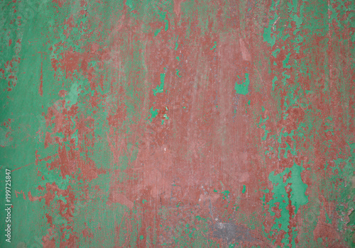 Weathered green red painted wall background partly faded