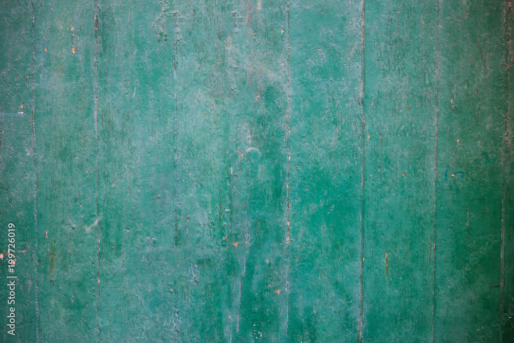 Weathered green painted wooden background partly faded