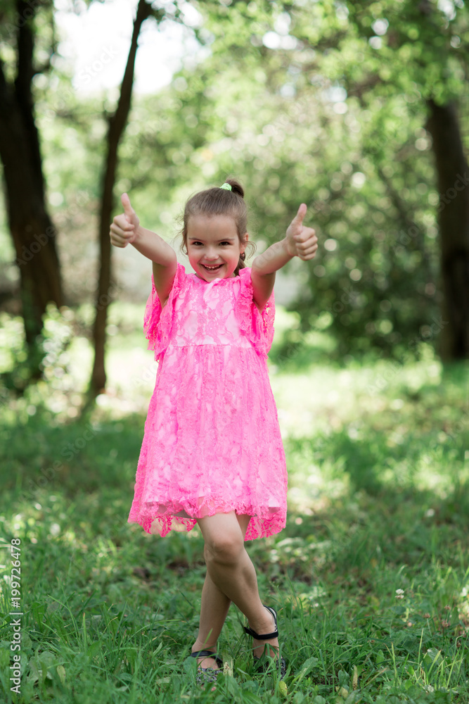 Fashion portrait of stylish girl smiling and posing at camera. Walking in park at summertime. Fashion portrait of stylish girl smiling and posing at camera. Walking in park at summertime.