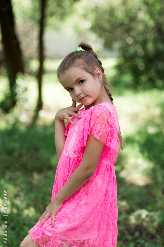 Fashion portrait of stylish girl smiling and posing at camera. Walking in park at summertime. Fashion portrait of stylish girl smiling and posing at camera. Walking in park at summertime.