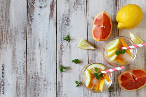 Summer drinks with grapefruit, lemon and ice. Top view. photo