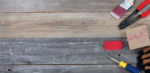 Fathers day gift box and tools on rustic wooden plank background