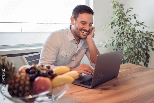 Happy young with his laptop