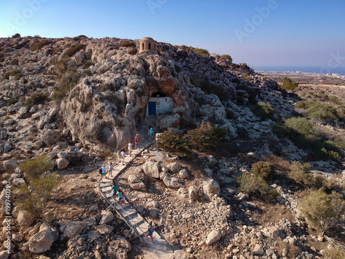 Group of tourists visiting Agioi Saranta cave church in Cyprus photo