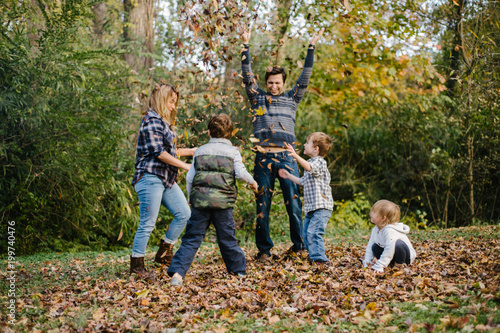 Family planning in autumn leaf pile