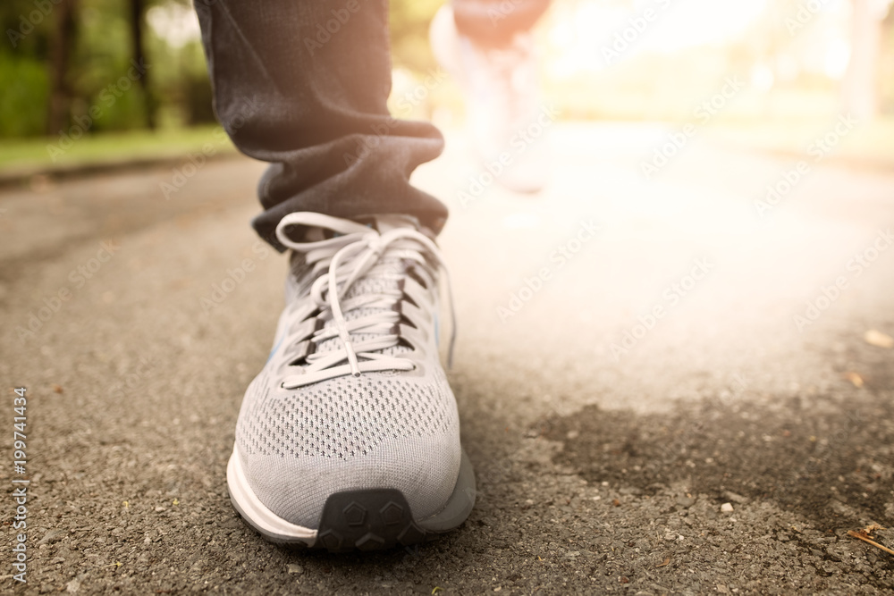 Female jogging in Central Park by wearing sports shoes.