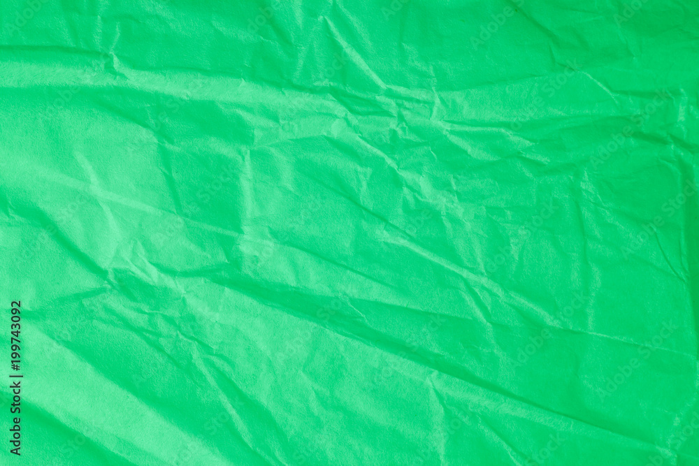 Fototapeta premium Green crumpled paper background.