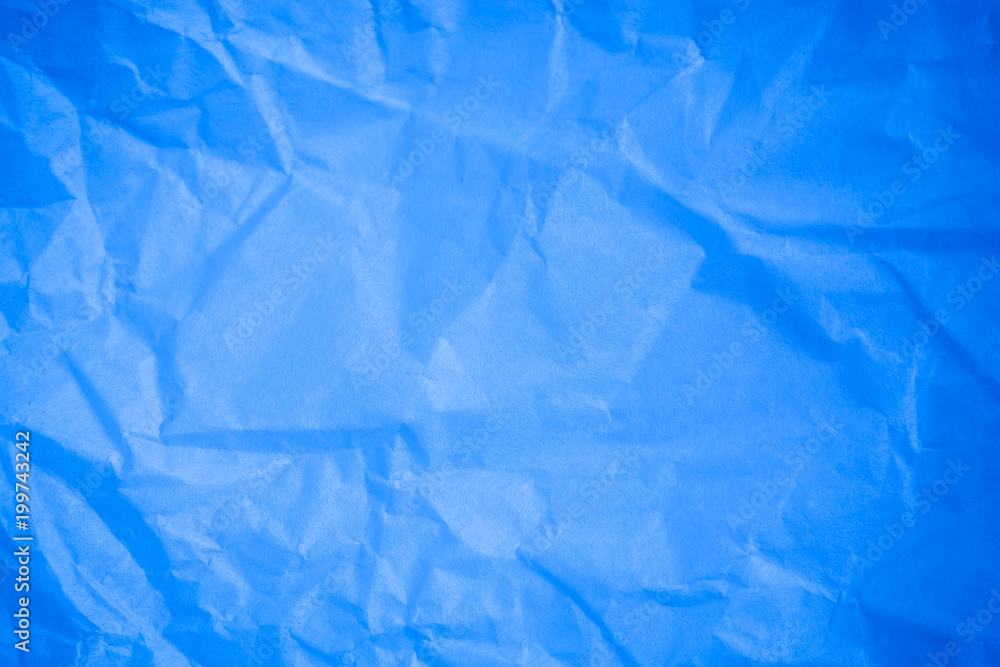 Obraz premium Crumpled blue paper background.