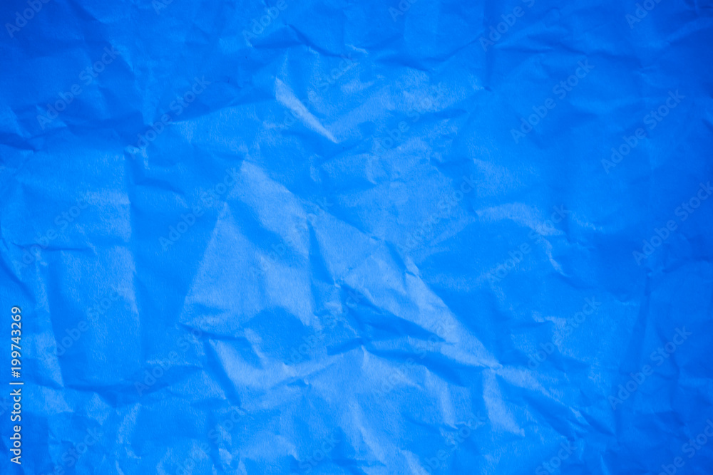Obraz premium Crumpled blue paper background.