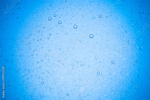 Rain droplets on blue glass background, Water drops on glass.