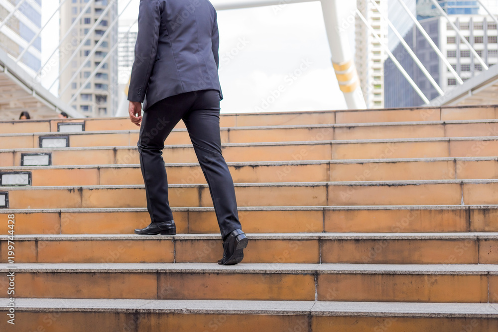 Business man going up the stairs in a rush hour to work. Hurry time. Business man going up the stairs in a rush hour to work. Hurry time.