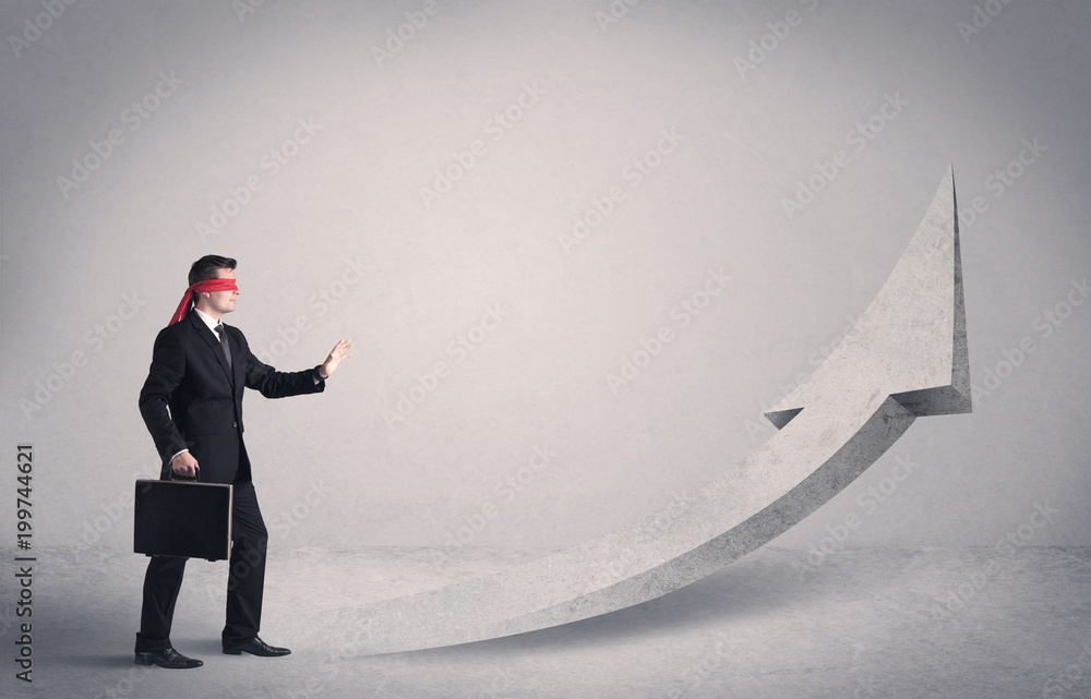 Obraz premium A scared blindfolded businessman forced to face a problem concept with illustrated arrow pointng to the sky in empty space.