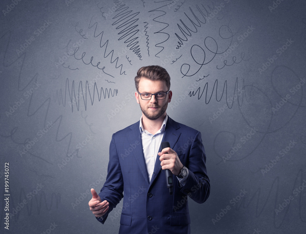 Businessman speaking into microphone with scribbles over his head Businessman speaking into microphone with scribbles over his head