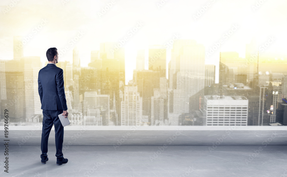 Businessman standing with his back on a roof with objects in his hand
Businessman standing with his back on a roof with objects in his hand