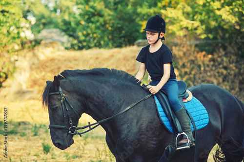 cheerful boy riding a horse, walking