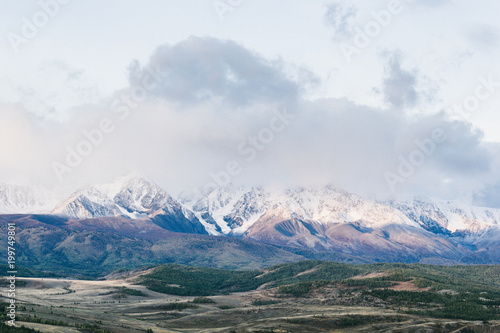 Beautiful view of the snowy mountain peaks. Colorful mountain valley with rocks. © Koirill