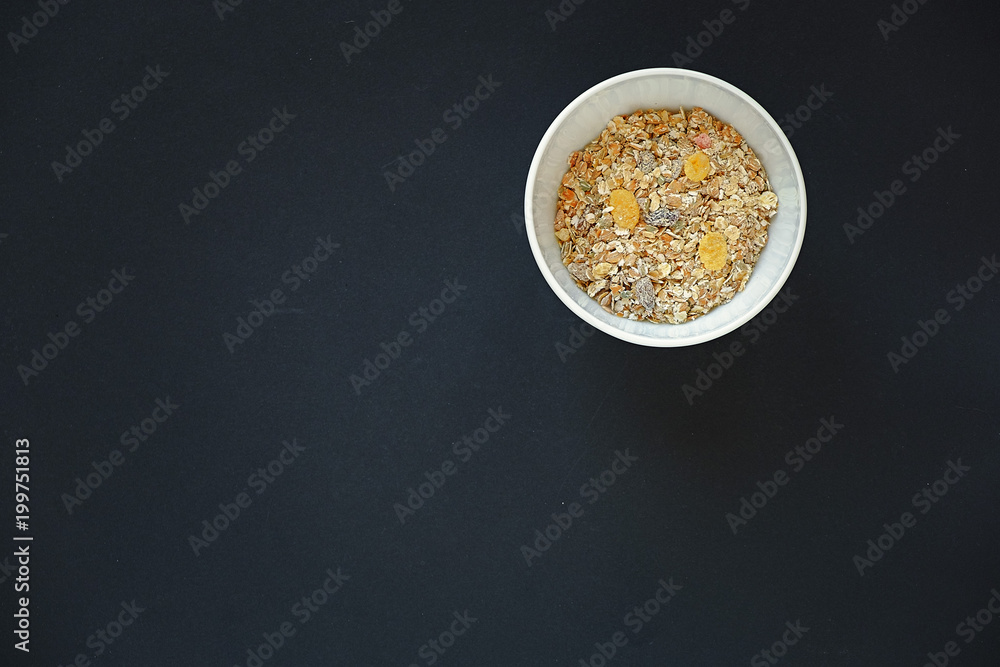 top view muesli in white bowl on black background top view with copy space top view muesli in white bowl on black background top view with copy space