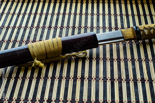 Fototapeta Naklejka Na Ścianę i Meble -  Japanese sword katana on bamboo mat