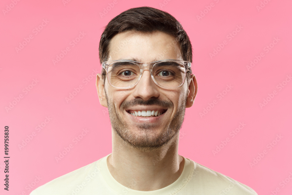 Positive emotions, facial expressions and happiness concept. Joyful modern optimistic man smiles broadly, shows white perfect teeth, isolated on pink background Positive emotions, facial expressions and happiness concept. Joyful modern optimistic man smiles broadly, shows white perfect teeth, isolated on pink background
