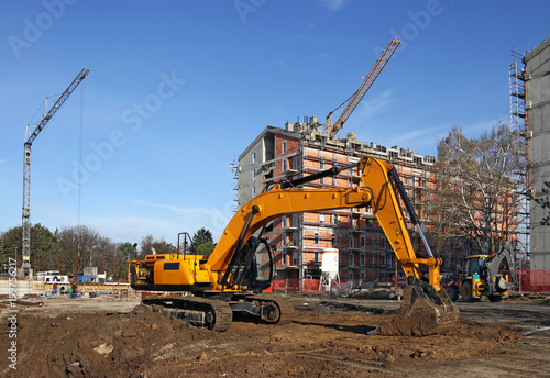 excavator and cranes on construction site