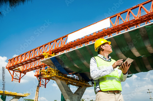 Male Engineer using tablet computer at construction site