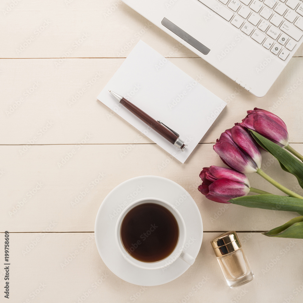 Office table with cup of coffee and flowers Office table with cup of coffee and flowers