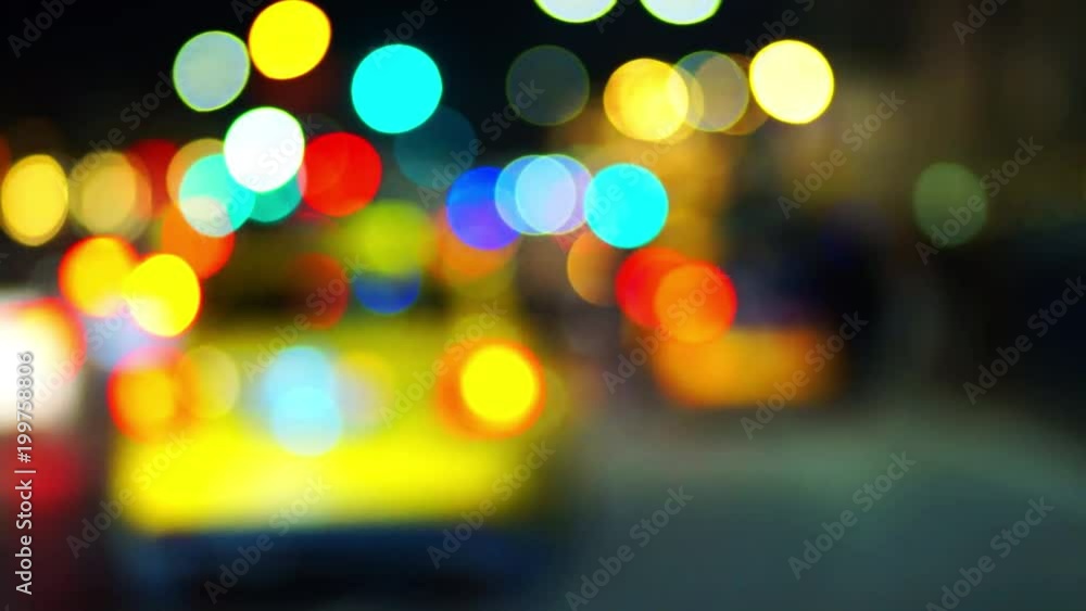 Defocused car lights. Round glare and bokeh of different colors as an excellent background or backdrop for video editing. Lights of the streets of the night city. Defocused car lights. Round glare and bokeh of different colors as an excellent background or backdrop for video editing. Lights of the streets of the night city.