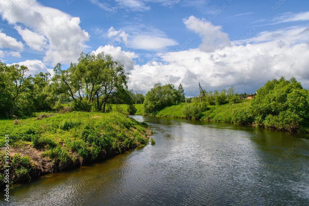 Landscape with a river and white clouds Landscape with a river and white clouds