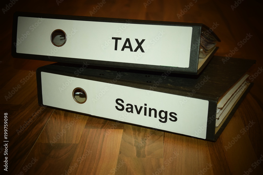 Two folders with labeling of tax and savings