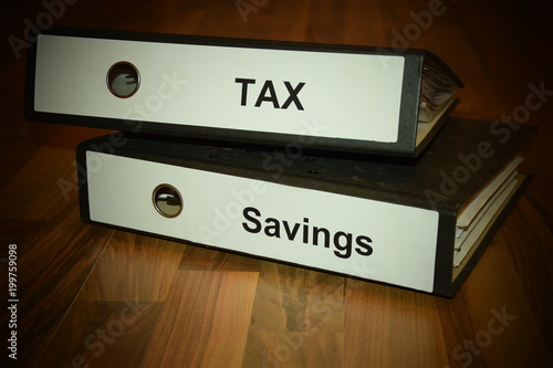 Fototapeta Naklejka Na Ścianę i Meble -  Two folders with labeling of tax and savings