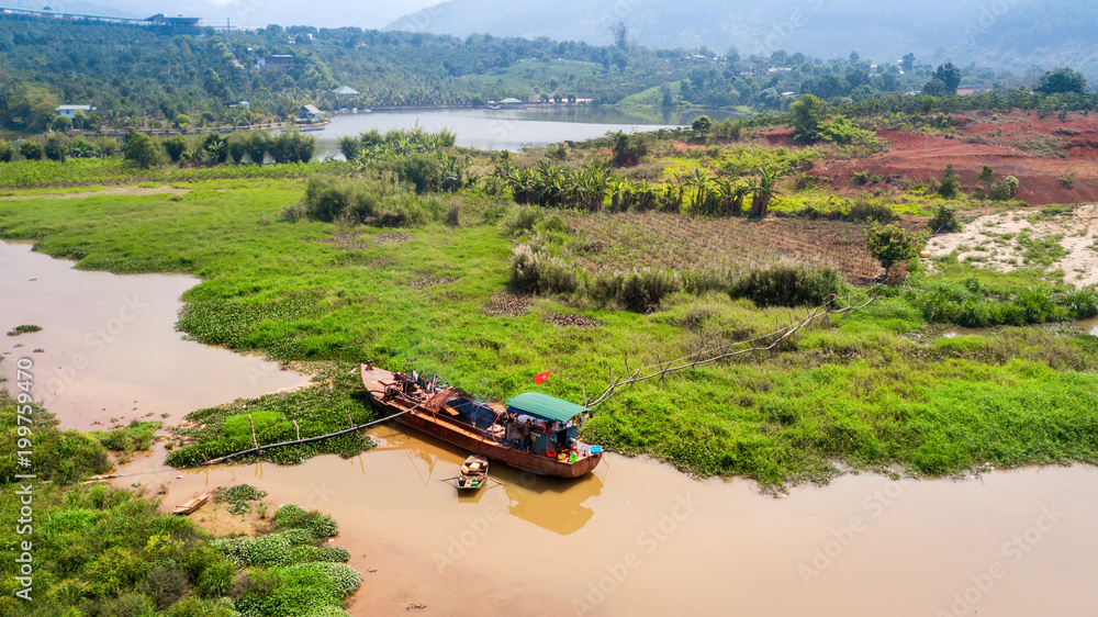 Fototapeta premium AERIAL 4K: Wooden boat as rural farm and house for everyday life on the river at North Vietnam