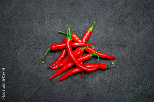 red chili pepper on dark concrete background