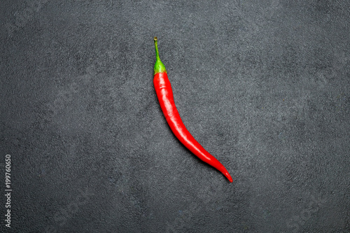 red chili pepper on dark concrete background