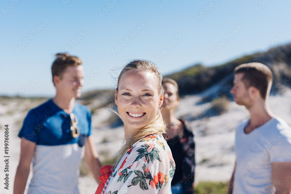 Happy friendly young woman on a sunny beach