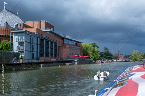 boats passing in front of the Royal Shakespeare Theatre photo