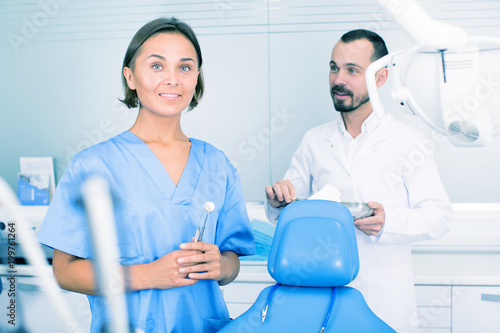 Dentist with assistant are fooling around in the workplace