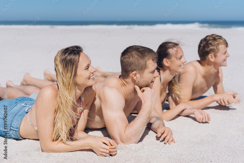 Group of four young friends at the seaside Group of four young friends at the seaside